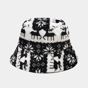 Winter plush bucket hat featuring black and white reindeer and snowflake patterns
