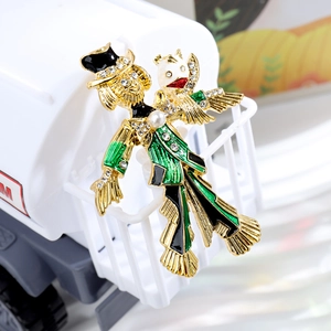 Elegant gold metal brooch with enamel character design, rhinestones, and a pearl accent