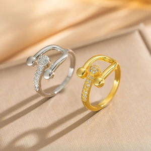 Macro detail of horseshoe adjustable rings with micro-pave cubic zirconia in gold and silver