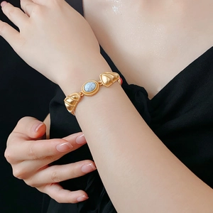 Close-up of vintage gold bracelet with white marble stone on woman wrist