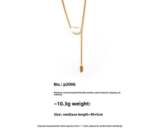 Detail of gold necklace with white enamel lucky bean pendant and steel chain dimensions