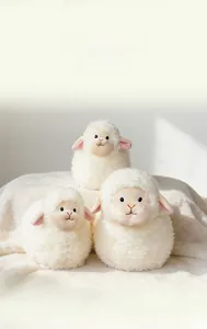 Three plush white sheep dolls in different sizes on soft fleece with cute facial embroidery