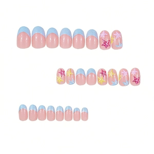 Short oval press-on nails with blue French tips and colorful star patterns