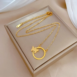 Detailed view of a gold titanium necklace featuring a butterfly and circle pendant charm