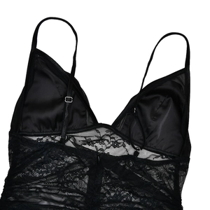 Detail of black lace dress with adjustable straps and rear zipper on silk fabric