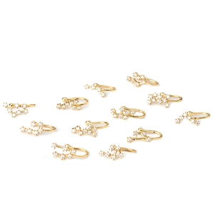 Zodiac copper nose rings with cubic zirconia stones in golden finish on white background