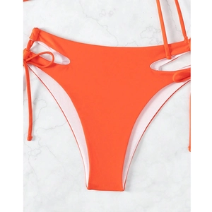 Detail of orange high-waist bikini bottoms with side cut-outs and drawstring lace-up ties