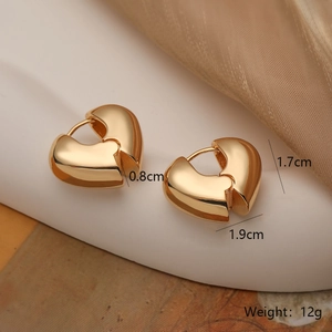 Detail view of heart-shaped gold-plated hoop earrings with size 1.9cm x 1.7cm and 12g weight