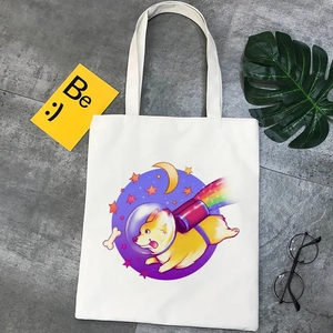 Kawaii beige canvas tote bag with cartoon Corgi astronaut print on stone background