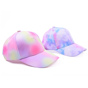 Detail of kids baseball hats featuring vibrant colorful tie-dye patterns and star designs