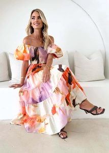 Artistic abstract print detail on a colorful off-shoulder summer maxi dress for women