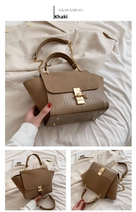 Detail of khaki wing bag featuring crocodile texture and suede flap with gold clasp