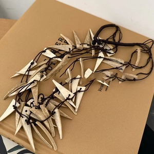 Ethnic multilayer necklace with off-white resin triangle charms on brown braided cord