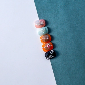 Detail of 5D nail stickers featuring white ballet dancer silhouettes on colorful tips