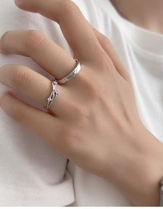 Close-up of S925 silver ring featuring a pink heart stone worn by a model in soft light