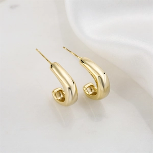 Minimalist 14K gold plated geometric C-shaped earrings on elegant marble and silk