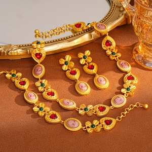 Vintage jewelry set with gold necklace and cameo earrings featuring floral accents