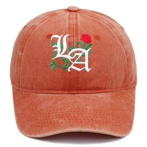 Macro detail of Gothic LA lettering and red rose embroidery on vintage washed canvas hat