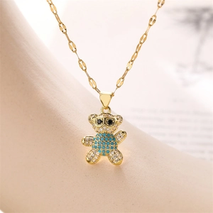 Macro shot of gold bear pendant with blue cubic zirconia and micro-pave crystals
