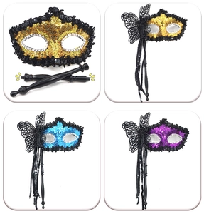Detail of glitter masquerade masks with lace butterflies, beads and hand-held sticks