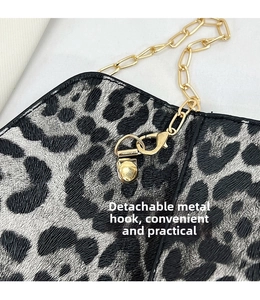 Detail showing high-quality gold hardware hook and leopard print leather texture