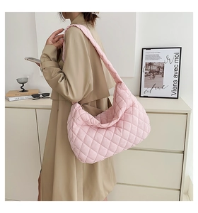 Close-up of pink quilted puffer shoulder bag in soft nylon with rhombohedral texture