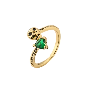 Gold skull ring with heart-shaped green emerald and black crystals in a gothic style