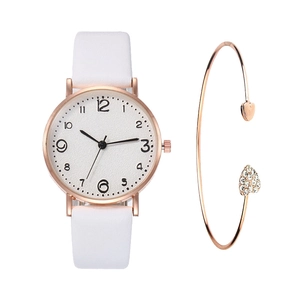 Detail of rose gold watch and heart bracelet set with rhinestones on white background