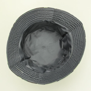 Detailed view of the gray fabric lining and reinforced stitching on camouflage hiking hat