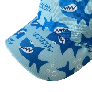 Kids baseball cap featuring a light blue shark print pattern for beach sun protection