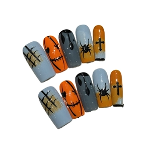 Handmade Halloween press-on nails with creepy spider and ghost face designs on orange tips