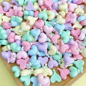 Close-up of heart-shaped candy-colored resin beads for DIY jewelry and nail art