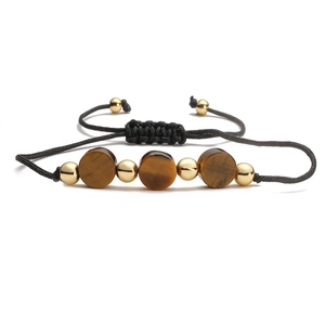 Handmade woven bracelet featuring tiger eye stone beads and gold metal spheres