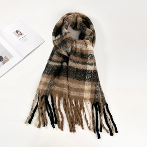 Close-up of soft plaid mohair scarf featuring brown and beige tassels and texture