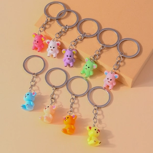 Detailed view of nine colorful resin bear keychains on geometric display stands