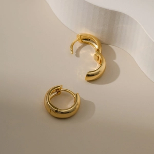 Detail view of 18k gold plated geometric hoop earrings showing hinge mechanism
