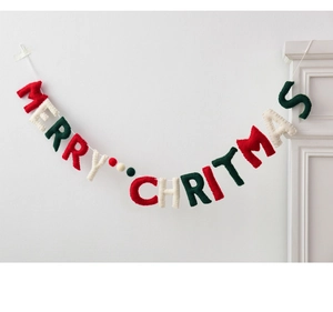 Felt Merry Christmas banner hanging on fireplace with red green and white letters