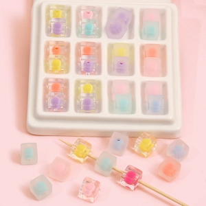 Colorful macaron acrylic square beads in a white organizer tray for DIY craft jewelry