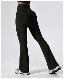 Close-up of ruched detail and high-waist fit on black flared yoga pants for lift