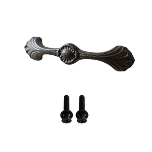 Vintage iron cabinet handle with leaf pattern and matching screws on white background