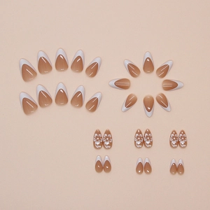Glossy almond press-on nails with white French tips and delicate floral patterns