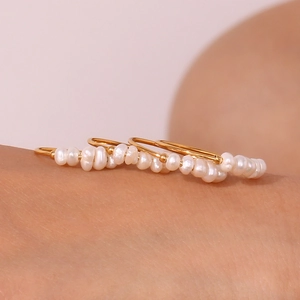 Detailed close-up of 18K gold plated stainless steel ring with natural freshwater pearls