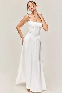 Detail of white satin dress featuring a unique V-shaped diagonal waist seam and slim fit