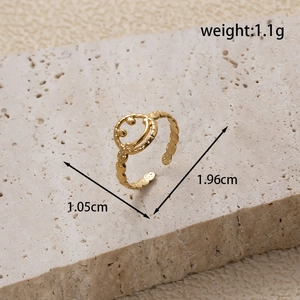 Adjustable gold smiley face stainless steel ring on natural stone background