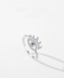 Macro shot of S925 sterling silver evil eye ring with blue zircon and pavé diamonds