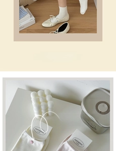 Detail of cream cotton socks with pink button accents styled with white Mary Janes