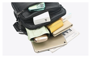 Detail view of large capacity black leather bag showing organized storage for tablets