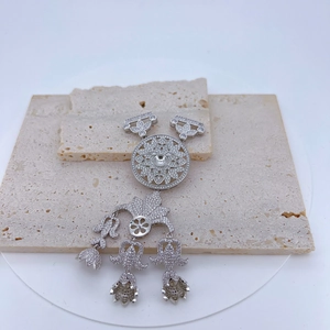 Detail view of silver double-layered sunflower pendant with crystals and floral tassels