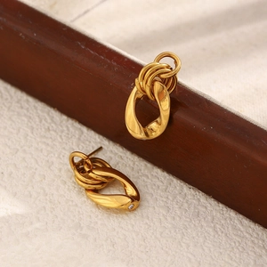 Detailed view of 18K gold plated chain earrings with interlocking rings and crystal inlay