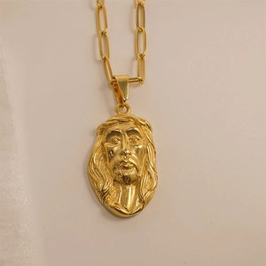 Detailed close-up of golden Jesus pendant with shimmering crystal stones on chain